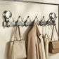 No-drill vacuum suction cup hook rack with multiple chrome hooks holding coats and bags