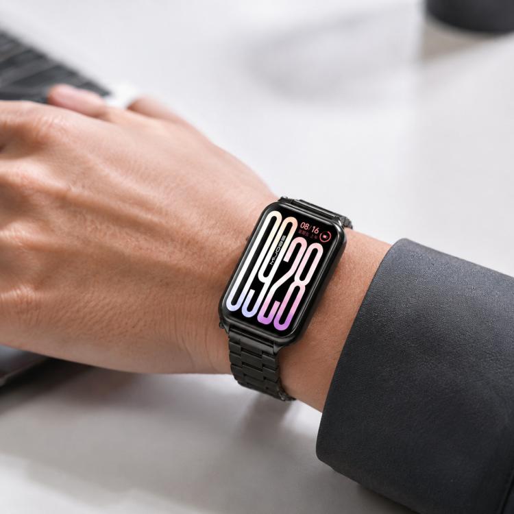 Black stainless steel link watch band worn on a wrist