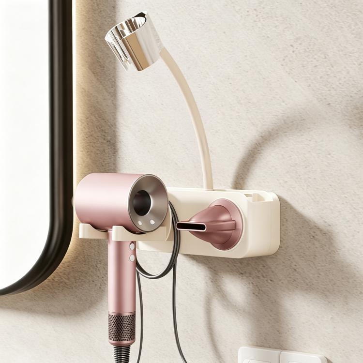 White suction-cup wall hair dryer holder with pink dryer, curved cable hook and nozzle cradle
