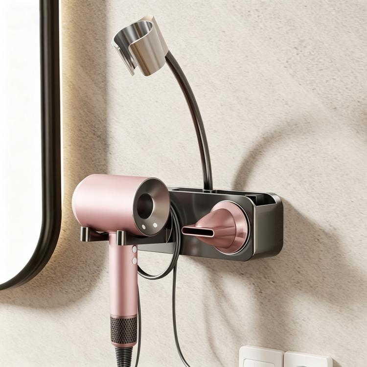 Grey suction-cup wall hair dryer holder with pink dryer, black cradle and cable loop
