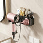 Suction-cup hair dryer wall rack holding pink dryer and grooming tools with black cradle