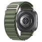 Olive green woven nylon watch band with silver G-hook buckle on a smartwatch