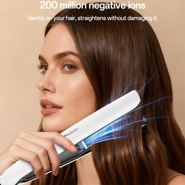 Hair straightener applying to brown hair with glowing mist effect near plates
