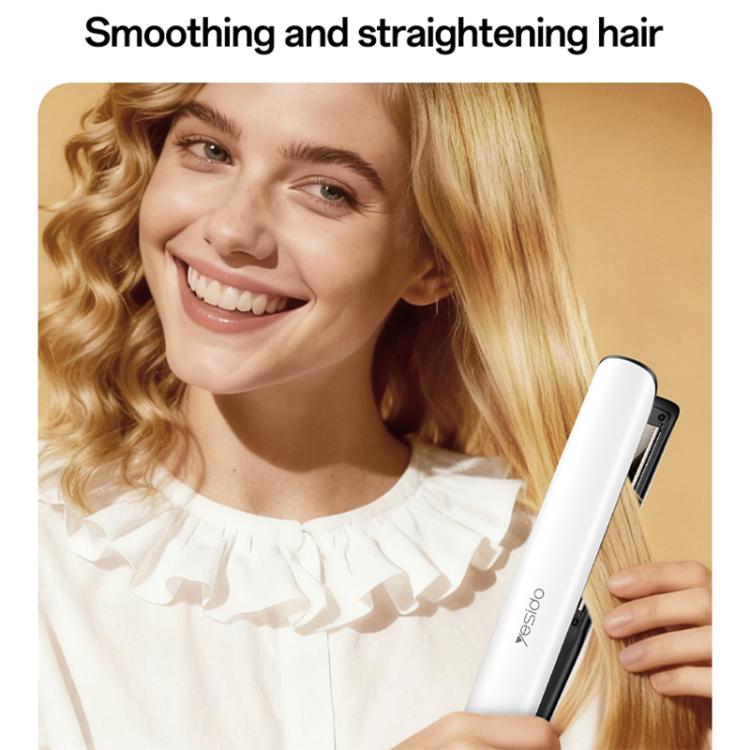 Hair straightener in hand smoothing blonde hair at the roots