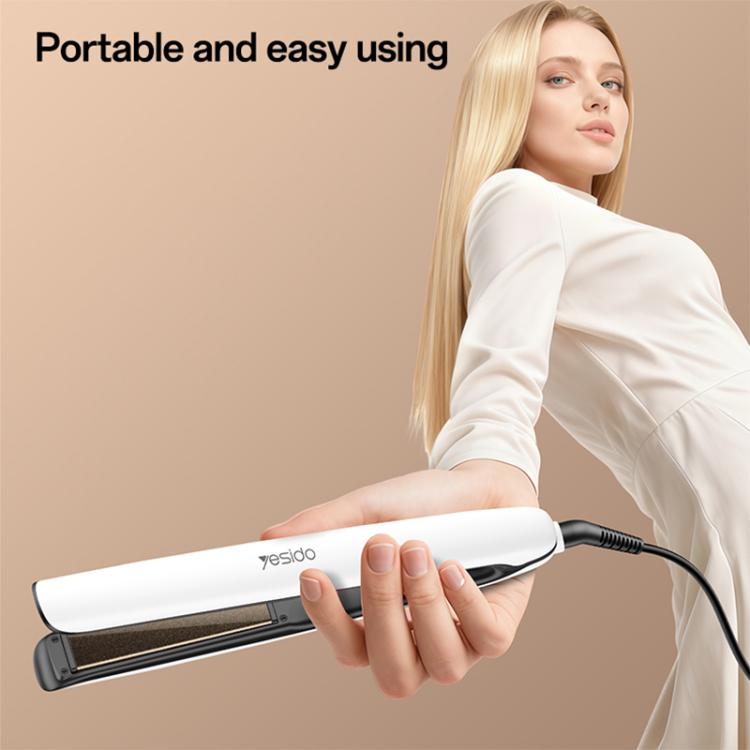 White hair straightener with black ceramic plates, held in hand, corded