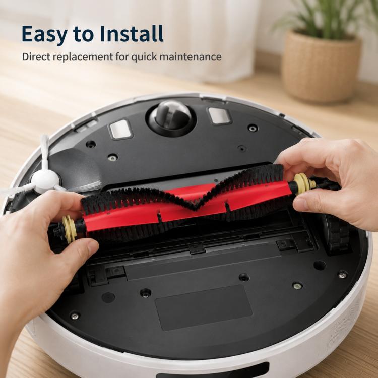 Hands installing a red and black main roller brush into the robot vacuum