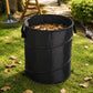 Black foldable camping bucket with leaves inside and side carrying straps