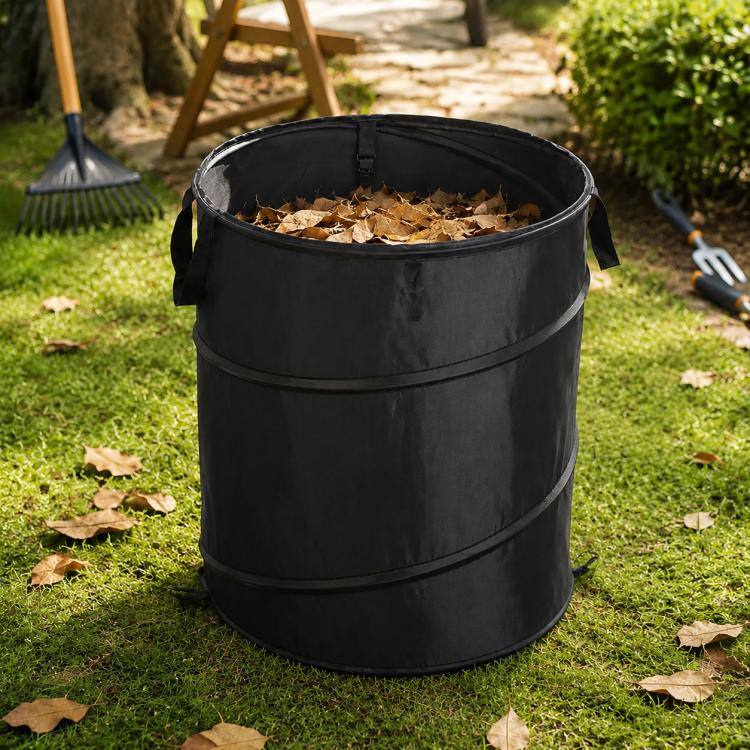 Black foldable camping bucket with leaves inside and side carrying straps
