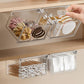 Pull-out transparent organizer tray with metal frame, holding toiletry items