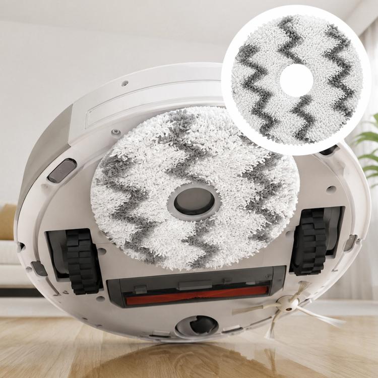 Round white mop pad with gray zigzag pattern installed on robot vacuum base