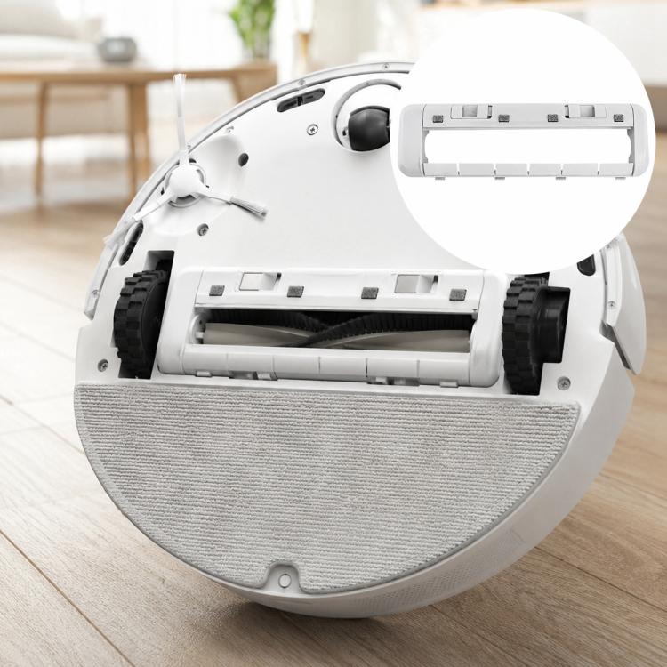 Robot vacuum underside with gray mop pad and open brush compartment