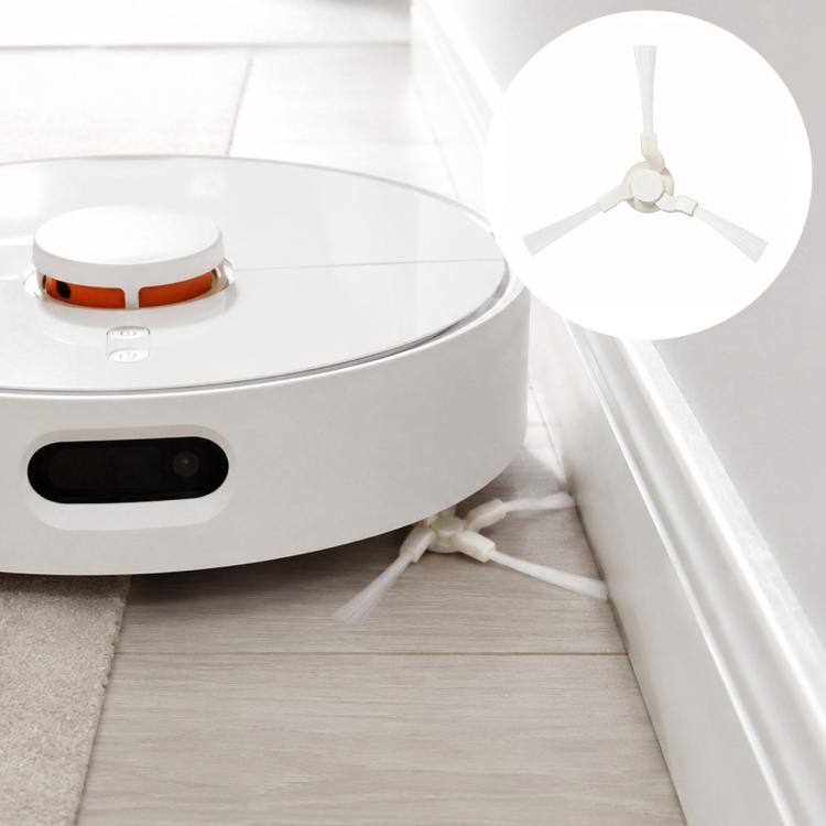 Robot vacuum with triangular side brush replacement piece installed near wall edge