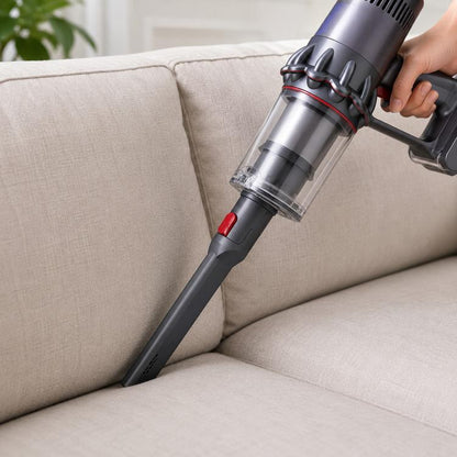 Long flat-nozzle brush head attached to vacuum, dark gray body with red nozzle tip.