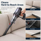 Long flat crevice tool cleaning sofa gap, dark gray head with red nozzle tip.