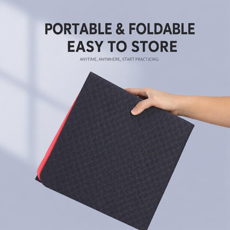 Foldable yoga mat, dark surface with red border, held folded for portability