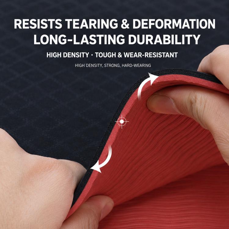 Yoga mat rolled edge close-up, red underside and black top showing thickness