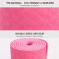 Pink double-sided non-slip yoga mat showing rolled spiral edge detail