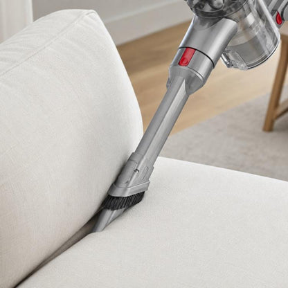 Gray narrow vacuum brush head with stiff bristles, angled for upholstery cleaning.