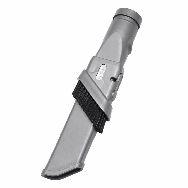 Gray retractable narrow brush head with stiff black bristles on vacuum attachment.