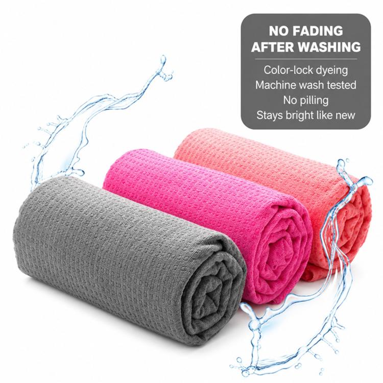 Folded gray and pink yoga towels with textured woven non-slip grip.