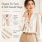 Cream satin tie-neck blouse with long puff sleeves and bow neckline, button cuffs