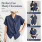 Women’s textured dark blue tie-neck button-front blouse with short rolled sleeves and asymmetrical hem.