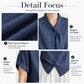 Women’s textured dark blue blouse detail: tie-neck collar and button-front placket.