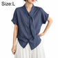 Women’s tie-neck button-front blouse in textured dark blue, model wearing size L.