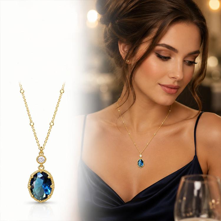 Gold-tone pendant necklace with oval blue stone and small round clear accent