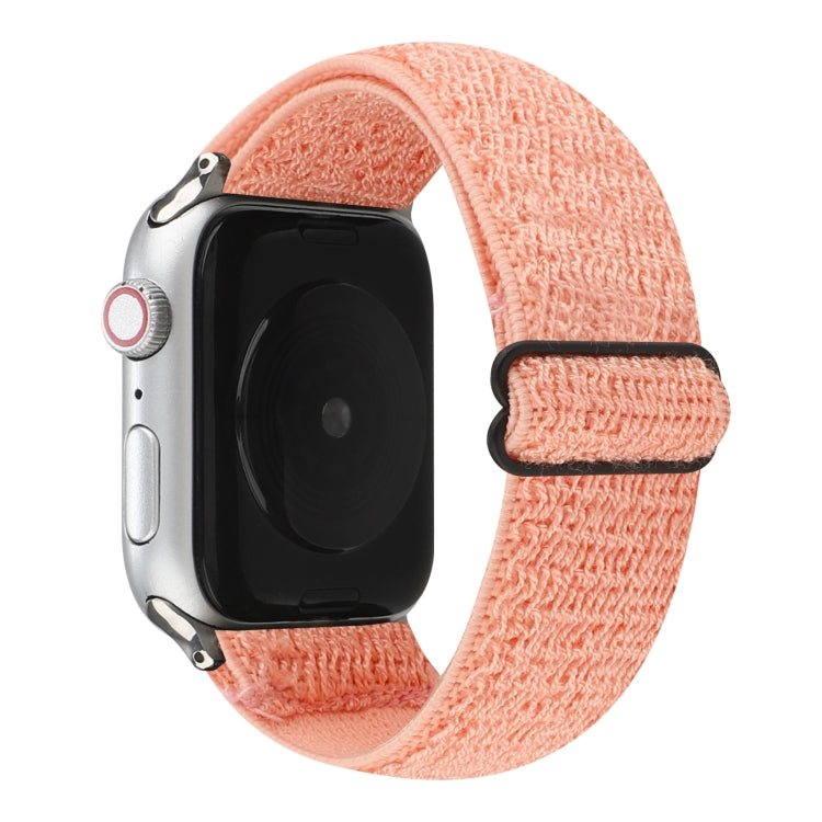 Coral pink stretchy nylon Apple Watch band with black hook-and-loop clasp