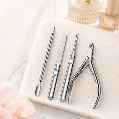 Stainless steel cuticle care tools set: nipper, pusher, fork, nail file on towel
