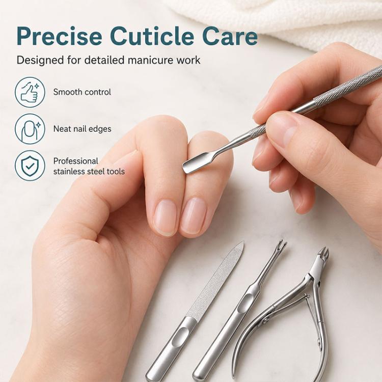 Stainless steel cuticle pusher tool used on fingernails with nail file and nipper nearby