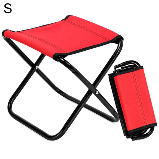 Small red folding outdoor stool chair with black frame and carry strap.