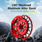 Red CNC-machined aluminum fishing reel spool with drilled slots and central hub
