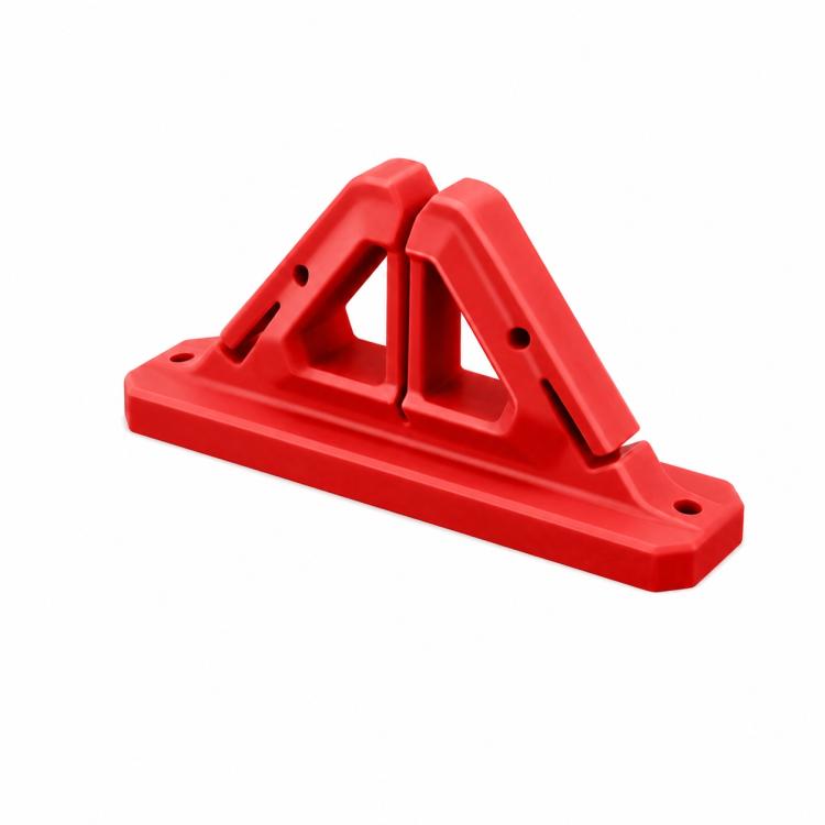 Wall-mounted fishing rod holder in red with two angled U-shaped grips and mounting holes
