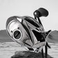 Side view of a black and chrome baitcasting fishing reel with crank handle and thumb bar