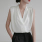 White satin V-neck sleeveless blouse with draped front and clean neckline