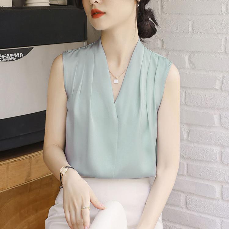 Light blue satin sleeveless V-neck blouse with pleated front and open neckline.