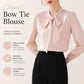 Pink satin bow-tie neck blouse featuring long sleeves and a tied collar bow