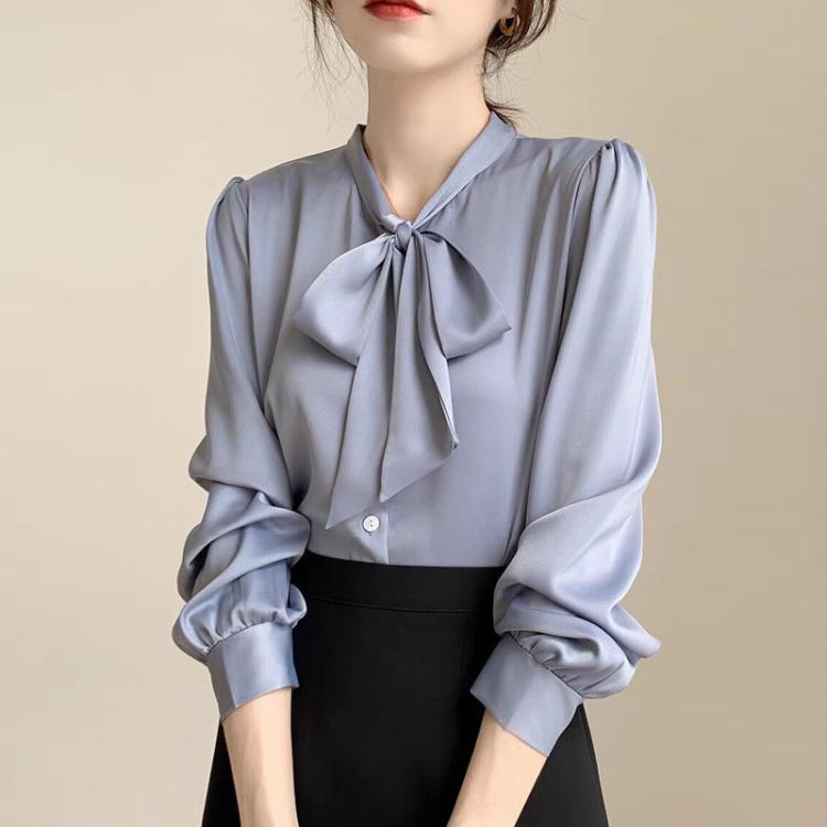 Light blue satin blouse with bow-tie neckline and long sleeves