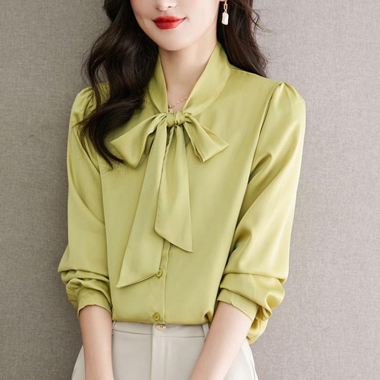 Yellow satin bow-tie neck blouse with long sleeves and button front, three-quarter view.