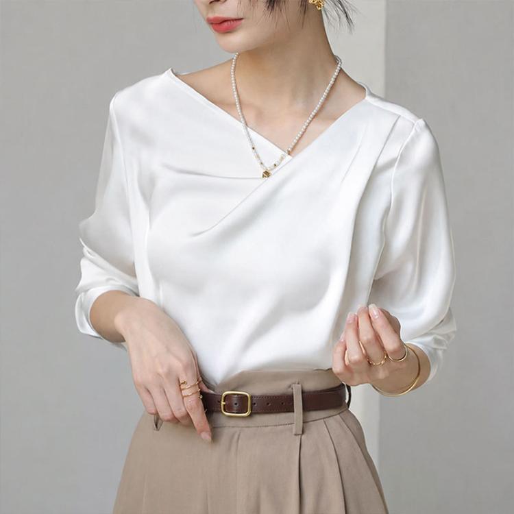 White satin blouse with diagonal V-neck and long sleeves, draped front