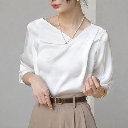 White satin blouse with diagonal V-neck and long sleeves, draped front
