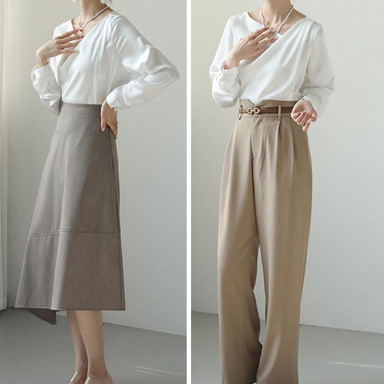 White diagonal V-neck satin blouse with long sleeves and straight hem