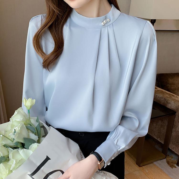 Light blue mock neck blouse with pearl button, long sleeves, pleated front