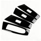 Four black window lift switch trim inserts with white rectangular cutouts