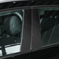 Black carbon fiber style B-pillar trim stickers installed on vehicle door panels