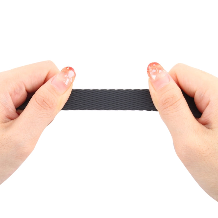 Charcoal woven silicone watch band held by hands
