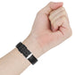 Black replacement watch strap on wrist with metal buckle and multiple holes