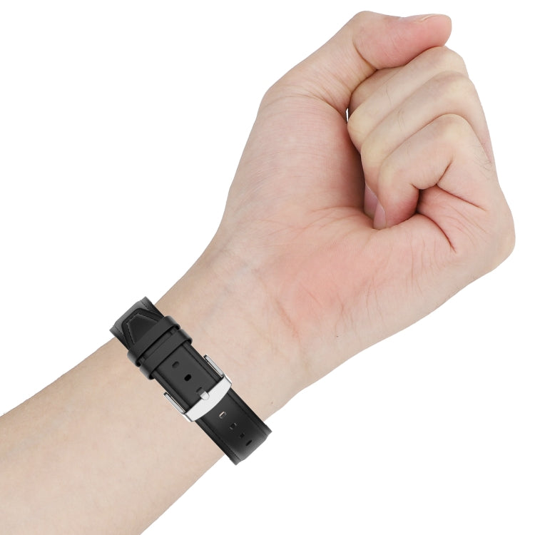 Black replacement watch strap on wrist with metal buckle and multiple holes